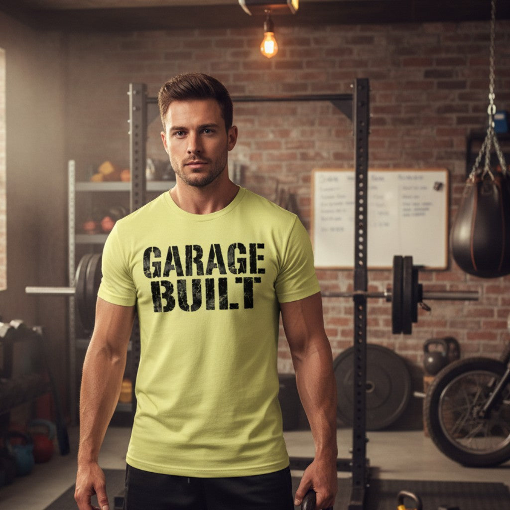 Garage Built Apparel men's light yellow CVC blend t-shirt with black "GARAGE BUILT" graphic. Model in gym.
